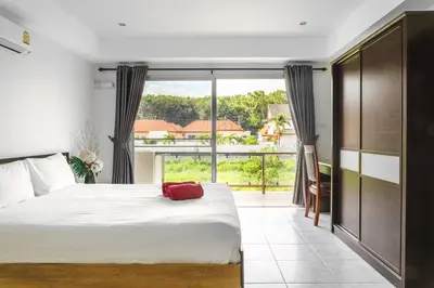 a bedroom with a bed and a large window at Condominium Rawai D1 - near convenience beach, market, gym in Rawai Beach
