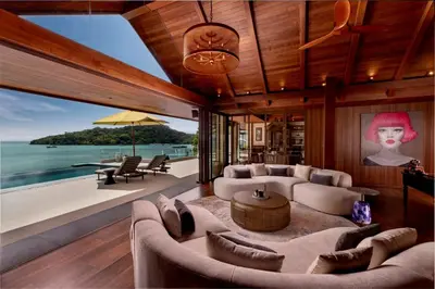 a living room with a view of the ocean at Villa Eugenia in Phuket Town
