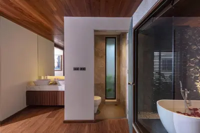 a bathroom with a tub and a toilet and a sink at Villa Eugenia in Phuket Town