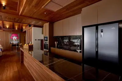 a kitchen with a counter and a dining room at Villa Eugenia in Phuket Town