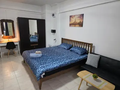 a bedroom with a large bed and a table at Monkey Apartment 38 in Patong Beach