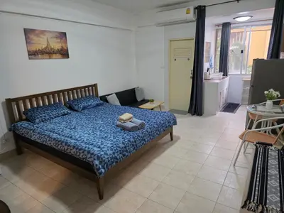 a bedroom with a bed with a teddy bear on it at Monkey Apartment 38 in Patong Beach