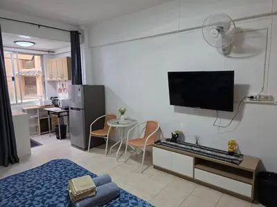a living room with a flat screen tv on the wall at Monkey Apartment 38 in Patong Beach