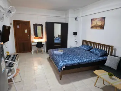 a bedroom with a bed and a living room at Monkey Apartment 38 in Patong Beach