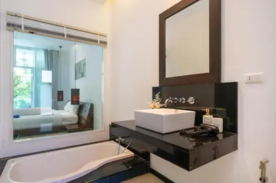 a bathroom with a sink and a mirror and a tub at Private pool villa in the heart of Bangtao in Bang Tao Beach