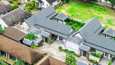 an overhead view of a row of houses with roofs at summer stay pool villa in Ban Na Bon