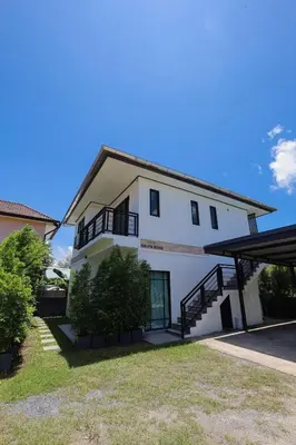 a large white building with a porch and stairs at RinFin Beach House - Bangtao in Ban Thalat Choeng Thale