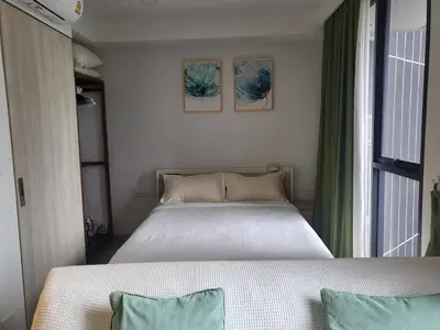 a bedroom with two beds and a window at Sky Park Laguna F4 in Laguna Phuket