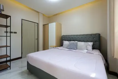 a bedroom with a large bed with white sheets and pillows at Haleema Signature Villa - Bangtao Beach in Ban Thalat Choeng Thale