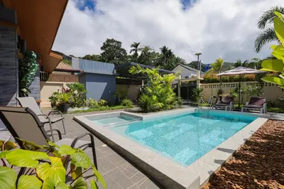 a swimming pool in the backyard of a house at Haleema Signature Villa - Bangtao Beach in Ban Thalat Choeng Thale