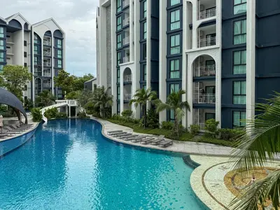 an image of a swimming pool in front of buildings at Modern 1 & 2 Bedroom Apartments Naiyang Phuket by Mango Family in Nai Yang Beach