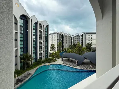 a view of a swimming pool with buildings at Modern 1 & 2 Bedroom Apartments Naiyang Phuket by Mango Family in Nai Yang Beach