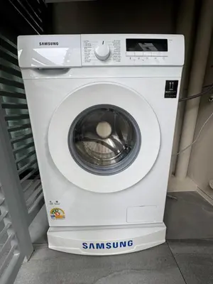 a white washing machine sitting in a room at Legendary Bang Tao in Phuket