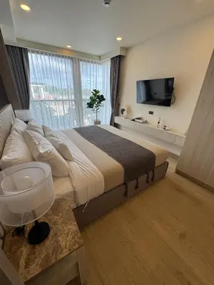a large bedroom with a large bed and a tv at New luxury condo Ozone next to Laguna in Phuket
