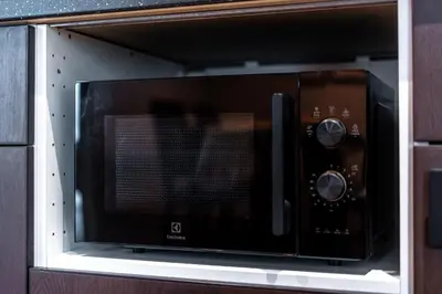a microwave oven sitting on top of a shelf at Title Halo Time For Family Pool Gym Hammam in Nai Yang Beach