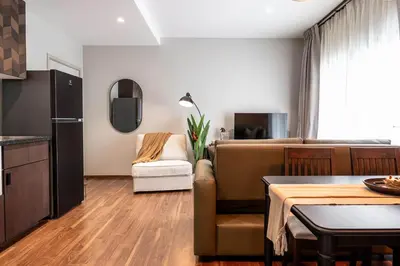 a kitchen and living room with a couch and a table at Title Halo Time For Family Pool Gym Hammam in Nai Yang Beach