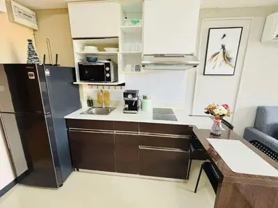 a small kitchen with a refrigerator and a sink at MBC Condotel Maikhao beach in Mai Khao Beach