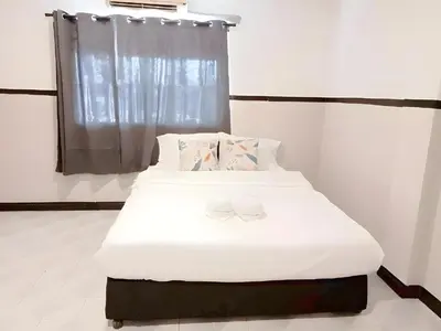 a bedroom with a bed with white sheets and a window at xx Mitr Inn - Phuket Old Town มิตรอินน์ ภูเก็ต เมืองเก่า 3 in Phuket Town