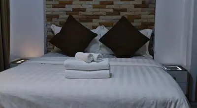 a bed with two towels and two pillows at Palm Spring 301 in Patong Beach