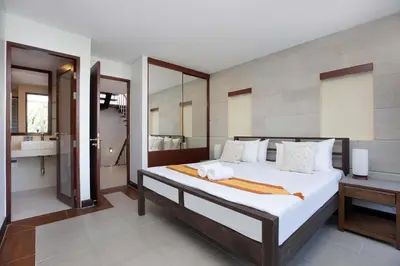 a bedroom with a large bed and a bathroom at 3 BR Villa with swimming pool near golf and airport - Argent 10 in Thalang