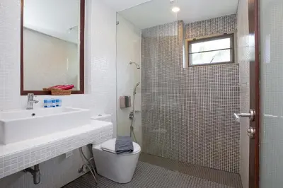 a bathroom with a sink and a toilet and a mirror at 3 BR Villa with swimming pool near golf and airport - Argent 10 in Thalang
