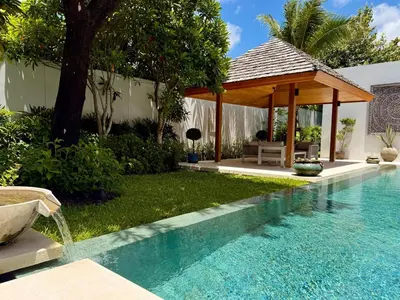 a swimming pool with a gazebo in a backyard at Peaceful villa in the heart of the Anchan Tropicana project in Ban Phru Champa