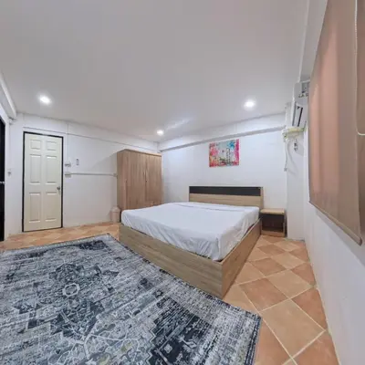 a bedroom with a bed and a rug at Stay 94 Patong in Patong Beach