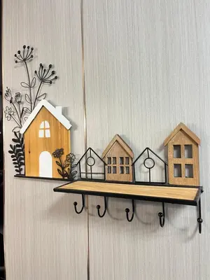 a wooden shelf with houses on it on a wall at Ali House Patong in Patong Beach