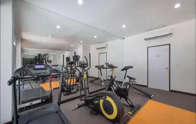 a gym with several treadmills and elliptical machines at Комфортные апартаменты Пхукет NBC in Rawai Beach