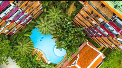 an overhead view of a swimming pool with palm trees at Комфортные апартаменты Пхукет NBC in Rawai Beach