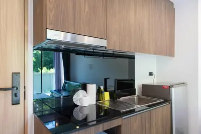 a kitchen with a sink and a counter top at Stylish Loft at Utopia Nai Harn great amenities in Rawai Beach