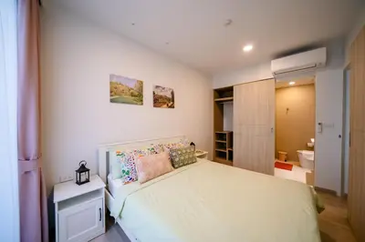 a bedroom with a bed and a bathroom at Sky park 2 bedroom 60m2 in Laguna Phuket