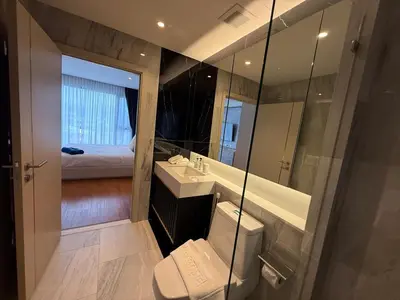 a bathroom with a toilet and a sink and a mirror at Bellevue lagoon 2 bedrooms in Laguna Phuket