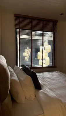a bedroom with a large white bed with a window at Ozone vista Rawai in Ban Saiyuan (1)