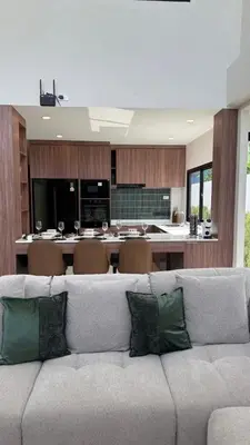 a living room with a couch and a kitchen at Ozone vista Rawai in Ban Saiyuan (1)