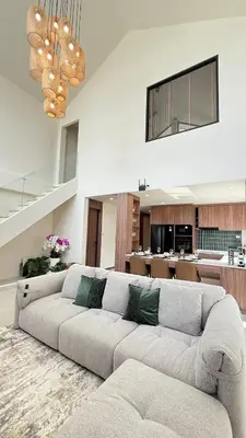 a living room with a large couch and a kitchen at Ozone vista Rawai in Ban Saiyuan (1)