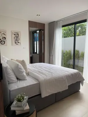 a bedroom with a large bed and a large window at Ozone vista Rawai in Ban Saiyuan (1)