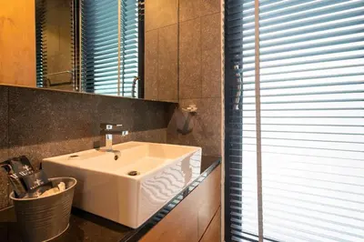 a bathroom with a white sink and a mirror at Sparrow Villa - Kamala Beach in Kamala Beach
