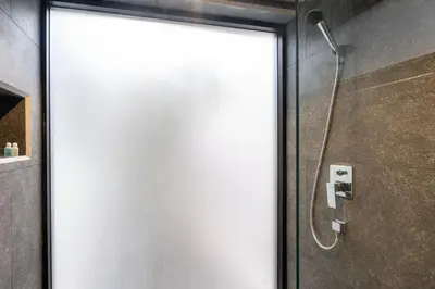 a white shower door in a bathroom at Sparrow Villa - Kamala Beach in Kamala Beach
