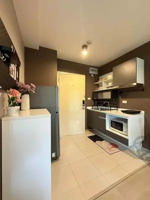 a kitchen with a stove and a refrigerator at Zcape garden view Phuket in Ban Rangeng