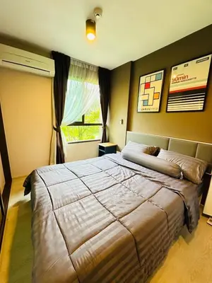 a bedroom with a large bed and a window at Zcape garden view Phuket in Ban Rangeng