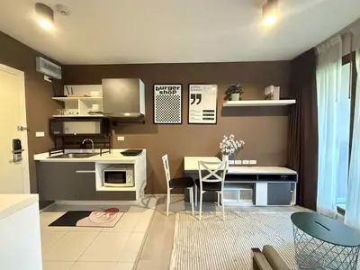 a kitchen with a table and chairs in a room at Zcape garden view Phuket in Ban Rangeng