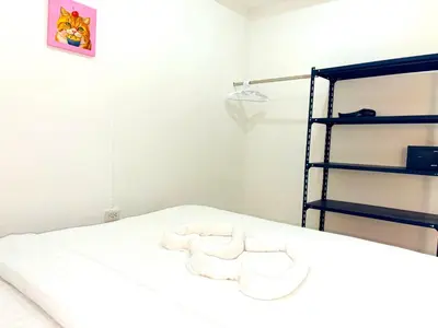 a room with two white chairs on a bed at Patong Canal Villa 109 in Patong Beach
