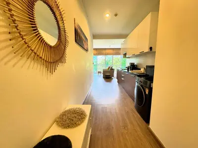 a kitchen with a table and a mirror on the wall at Veloche Peaceful Condo In Karon Beach in Karon Beach