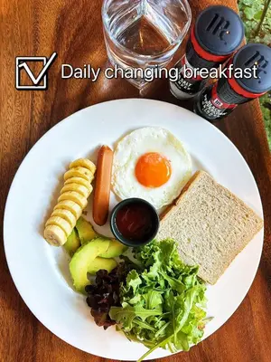 a plate of breakfast food with eggs bread and vegetables at Beanstay hostel in Phuket Town
