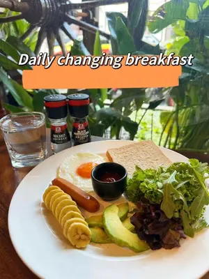 a plate of breakfast food with eggs sausage and vegetables at Beanstay hostel in Phuket Town
