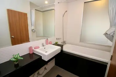 a bathroom with a sink and a tub and a white sink at Chic condominium A4 floor in Karon Beach