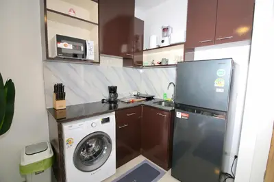 a kitchen with a washing machine and a washer at Chic condominium A4 floor in Karon Beach