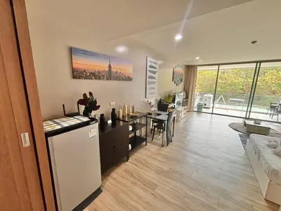 a living room with a kitchen and a dining room at Veloche 2 Floor in Karon Beach