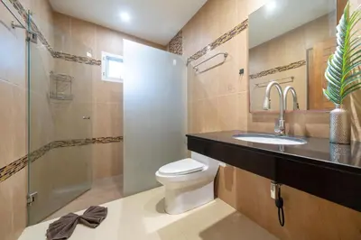 a bathroom with a toilet and a sink and a shower at Rawai Beach Villa in Rawai Beach